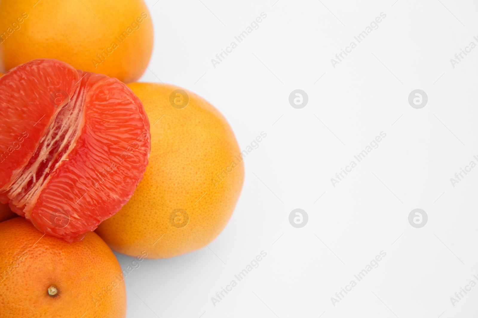 Photo of Many fresh grapefruits on white background, above view. Space for text