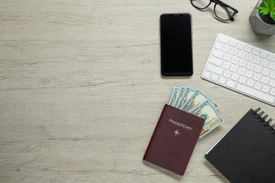 Photo of Flat lay composition with passport, dollars and smartphone on wooden table, space for text. Business trip