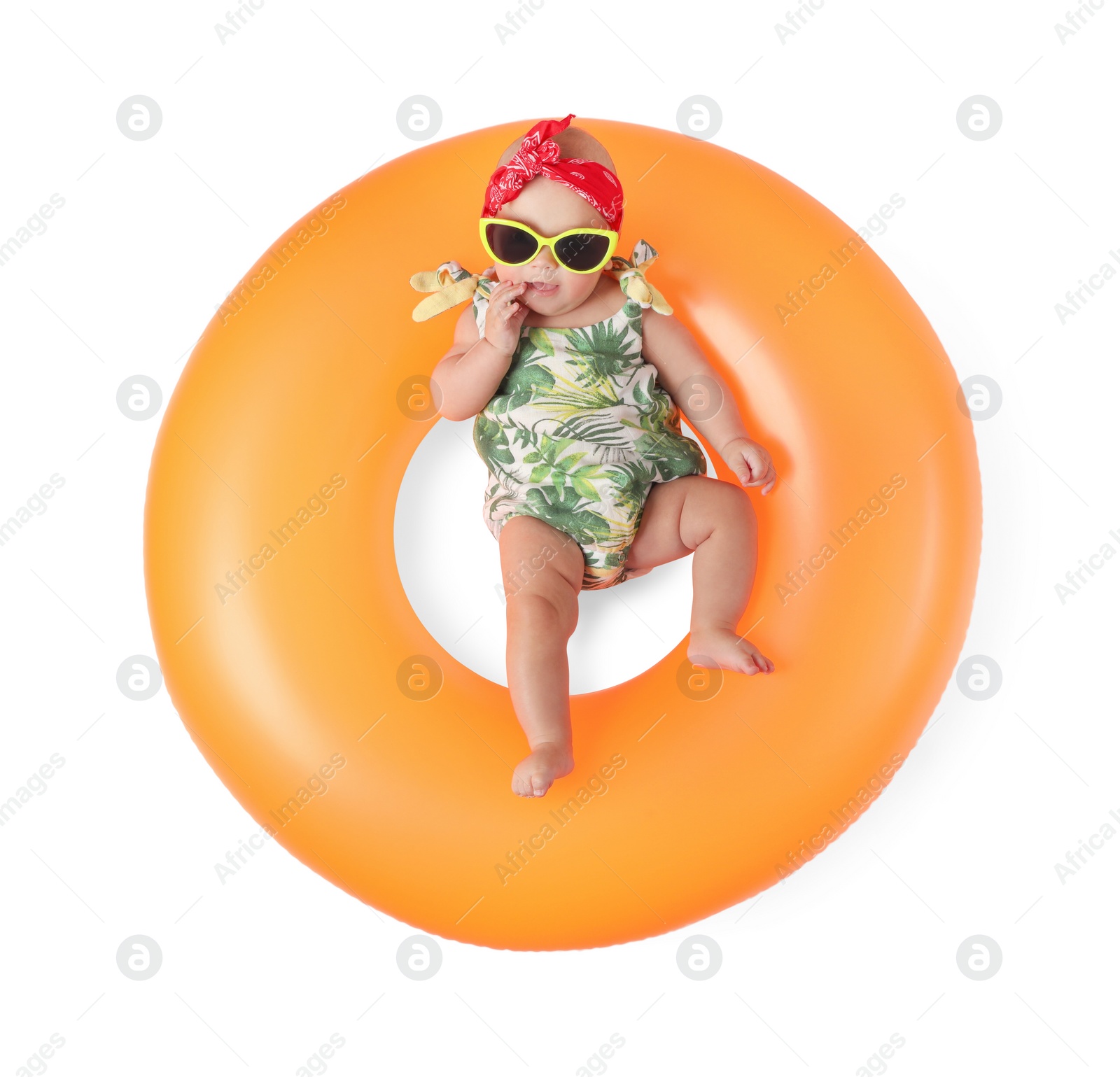 Photo of Cute little baby in sunglasses with inflatable ring on white background, top view