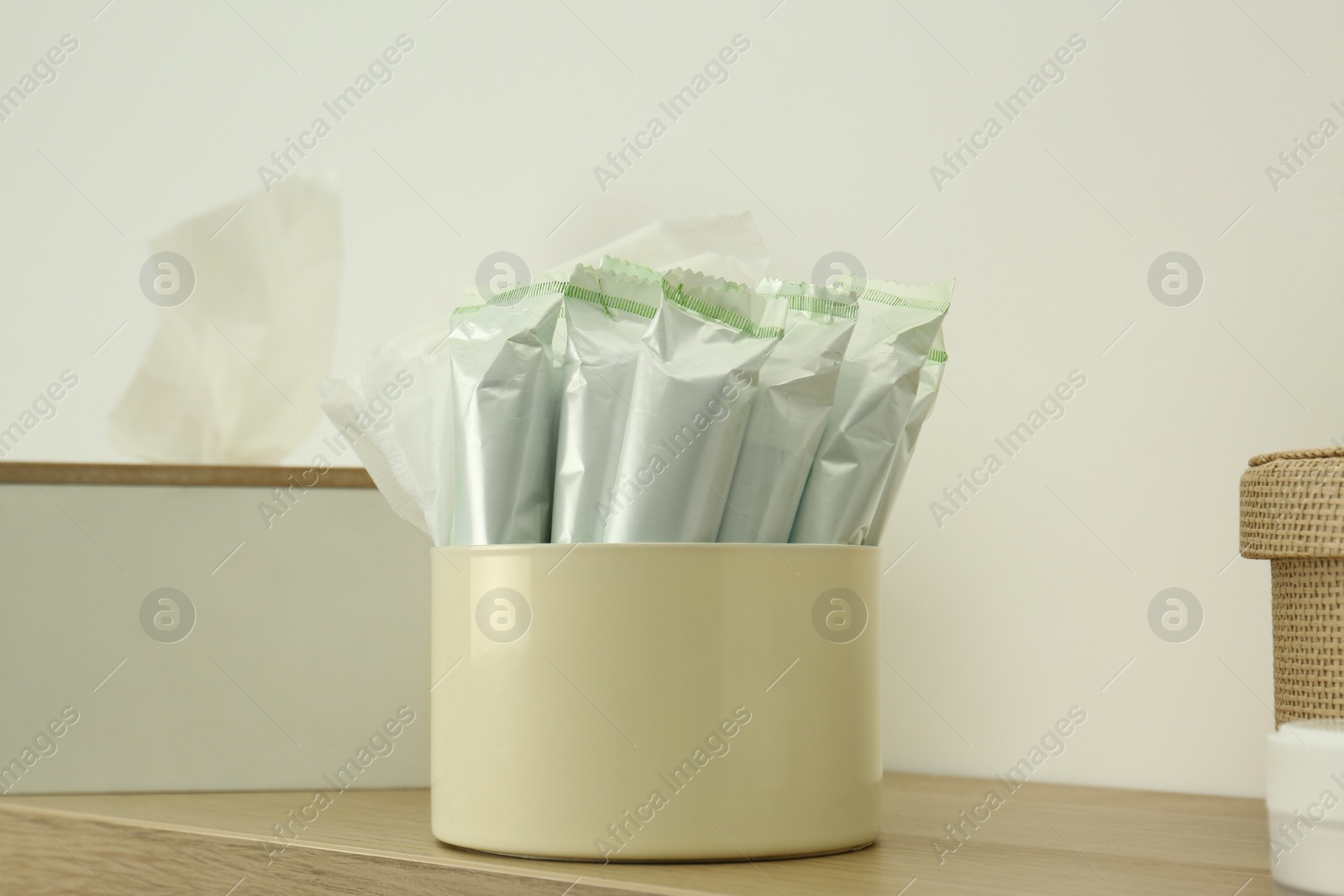 Photo of Different feminine hygiene products on wooden shelf, closeup