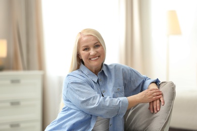 Photo of Portrait of happy mature woman at home