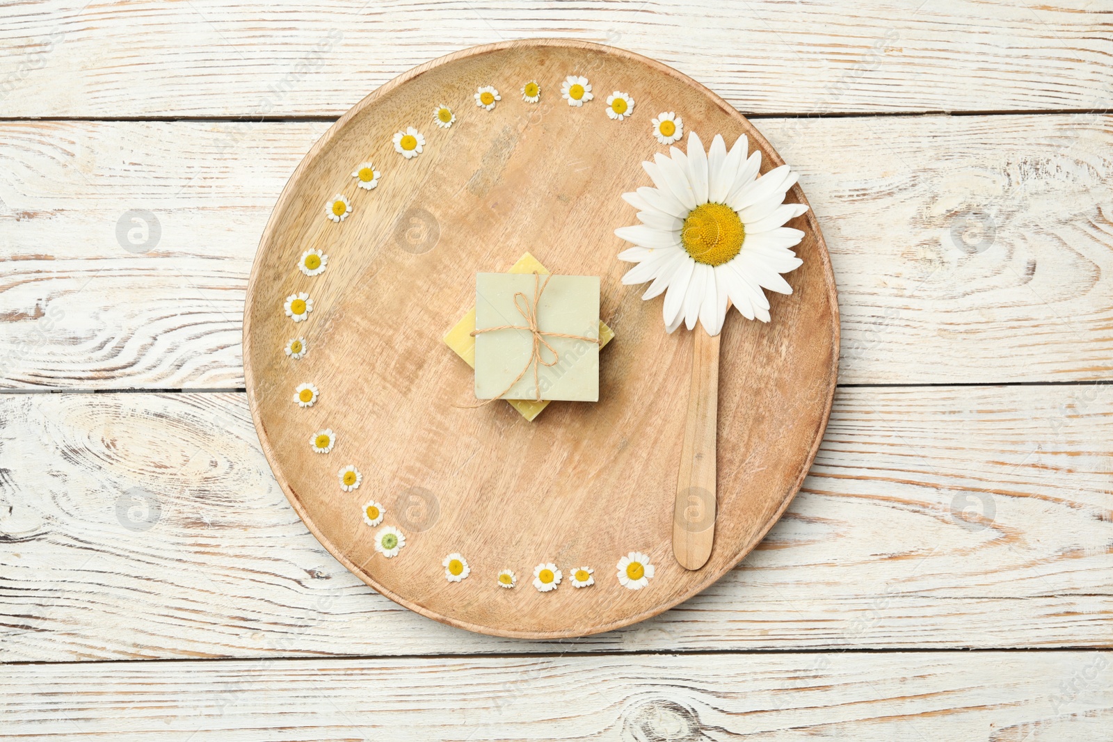 Photo of Composition with chamomile flowers on white wooden table, top view