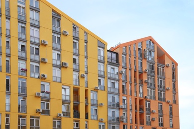 Photo of Colorful modern buildings with windows against sky. Urban architecture