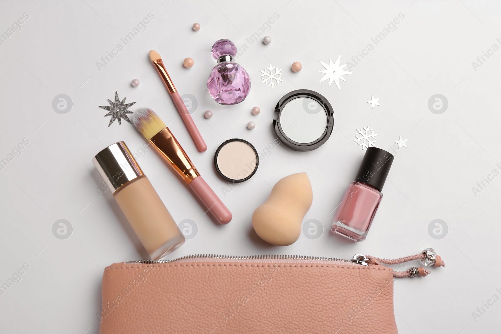 Photo of Flat lay composition with decorative cosmetic products and bag on light background. Winter care.
