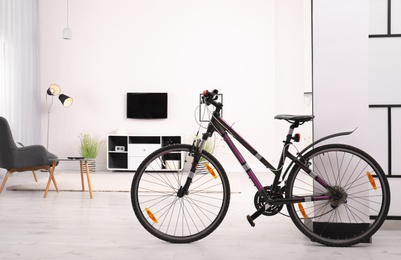 Light living room interior with modern bicycle