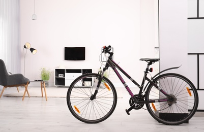 Photo of Light living room interior with modern bicycle