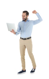 Photo of Emotional young man with laptop celebrating victory on white background