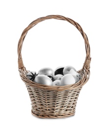 Photo of Basket with painted Easter eggs on white background