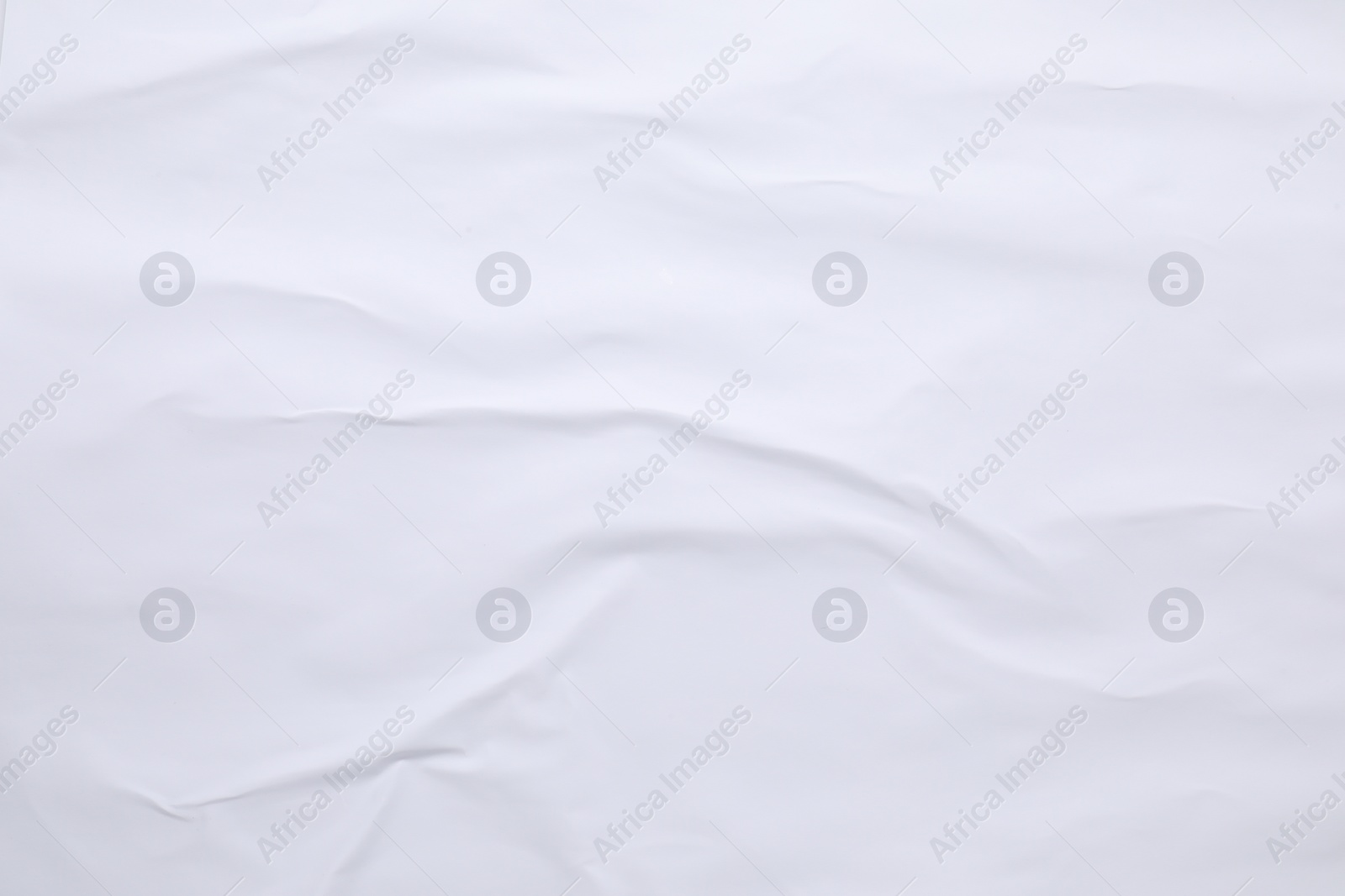 Photo of White crumpled sheet of paper as background, top view. Wall poster