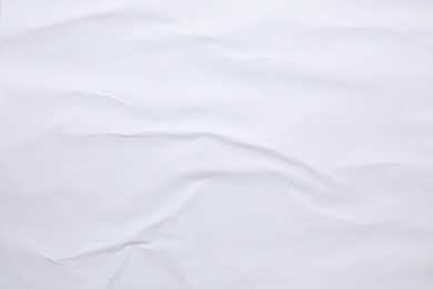 Photo of White crumpled sheet of paper as background, top view. Wall poster