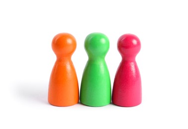 Photo of Colorful pawns on white background. Social inclusion concept