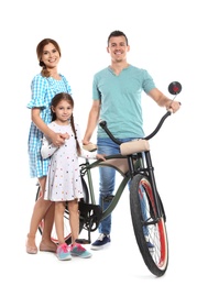 Portrait of parents and their daughter with bicycle on white background