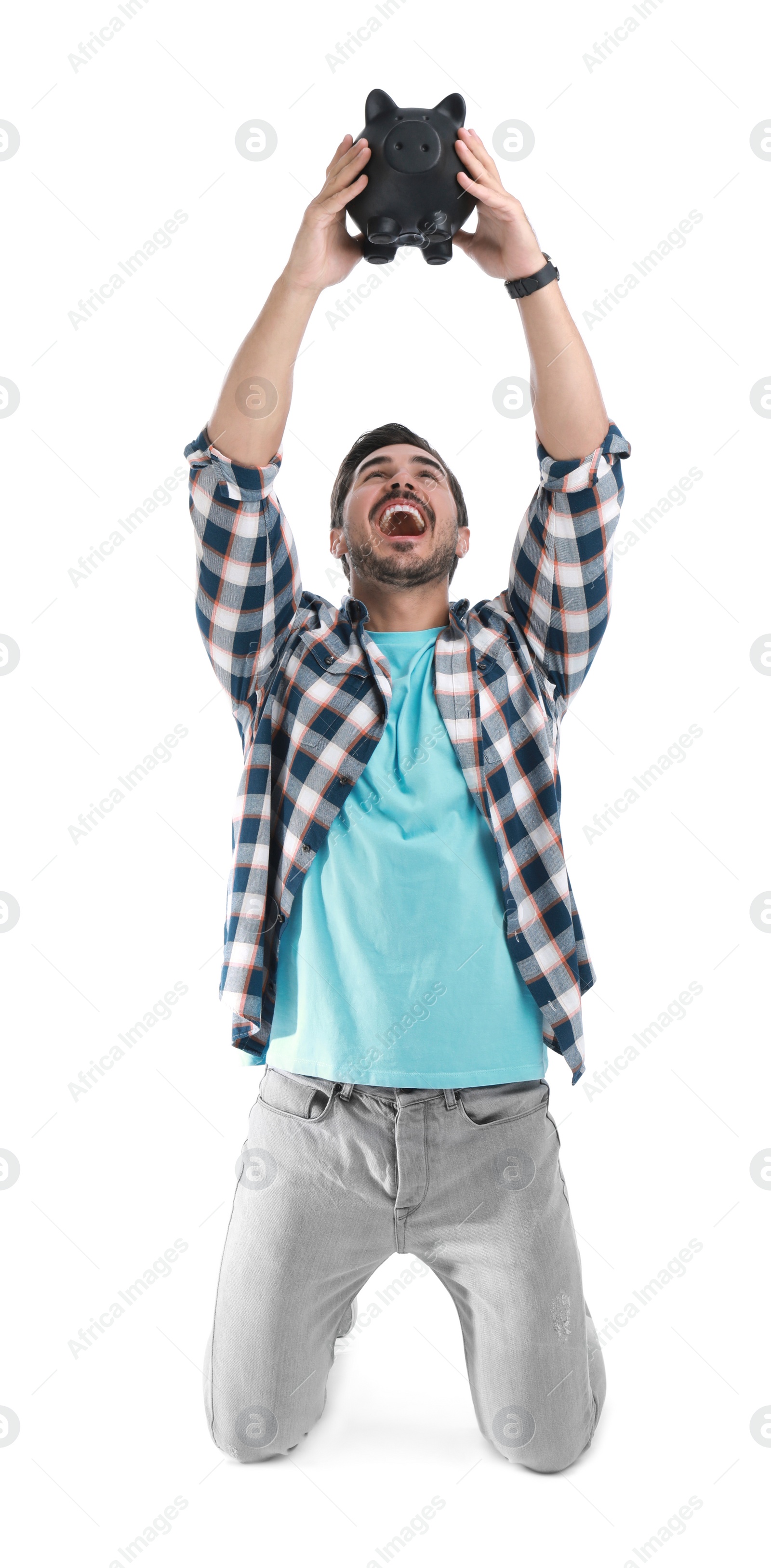 Photo of Handsome young man with piggy bank on white background