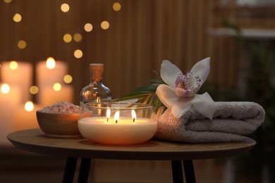 Composition with different spa products and orchid flower on wooden table