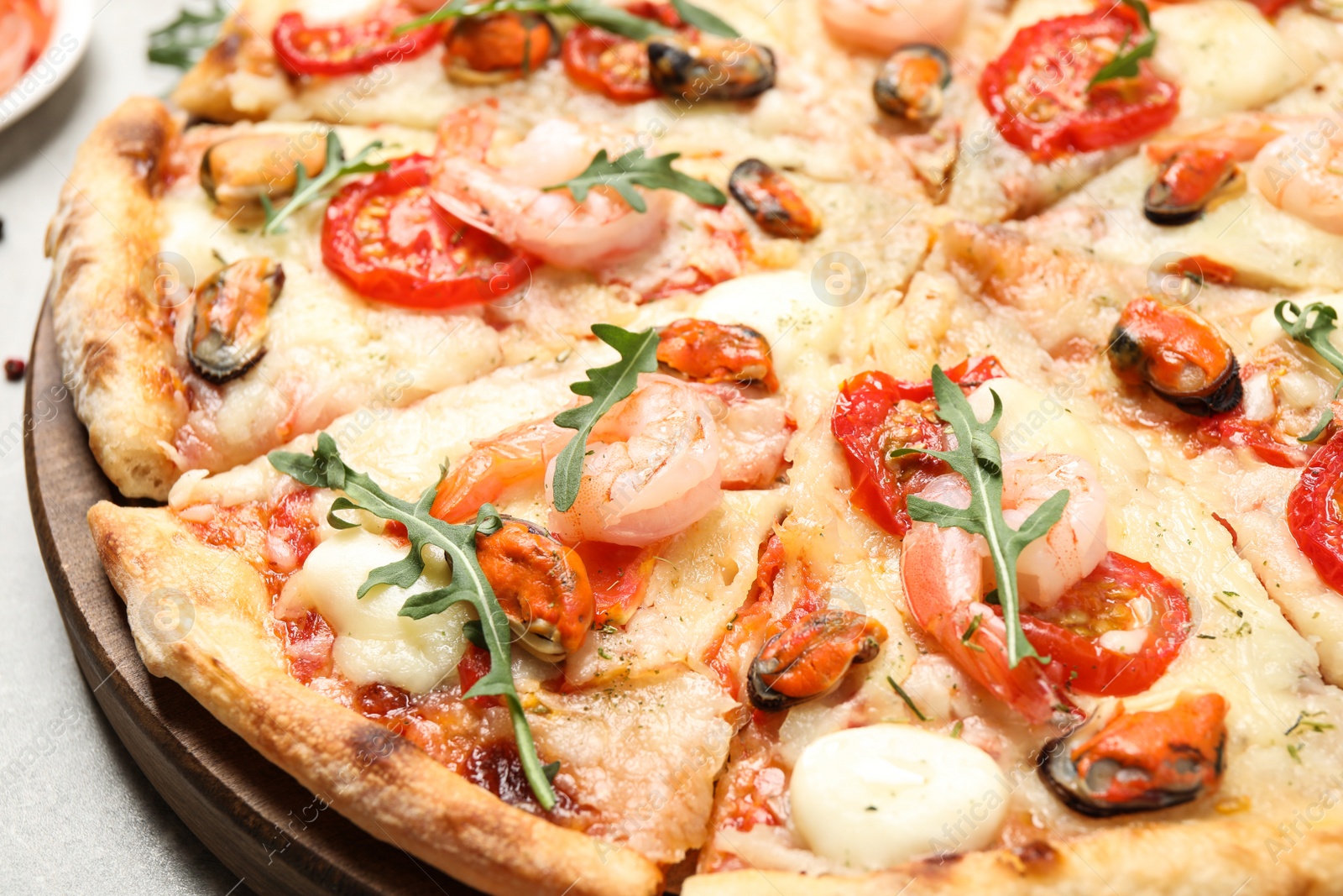 Photo of Closeup view of delicious fresh seafood pizza