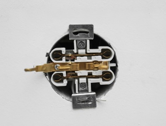 Photo of Disassembled socket on white background, closeup. Electrician's equipment