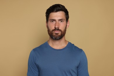 Portrait of handsome bearded man on yellow background