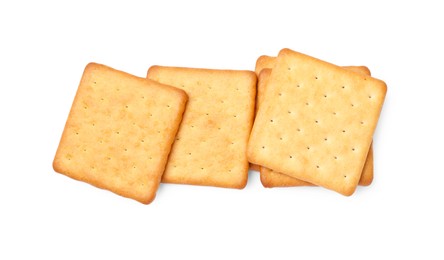 Photo of Many crispy crackers isolated on white, top view. Delicious snack