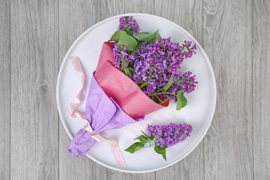 Beautiful blossoming lilac on table indoors, top view. Spring flowers