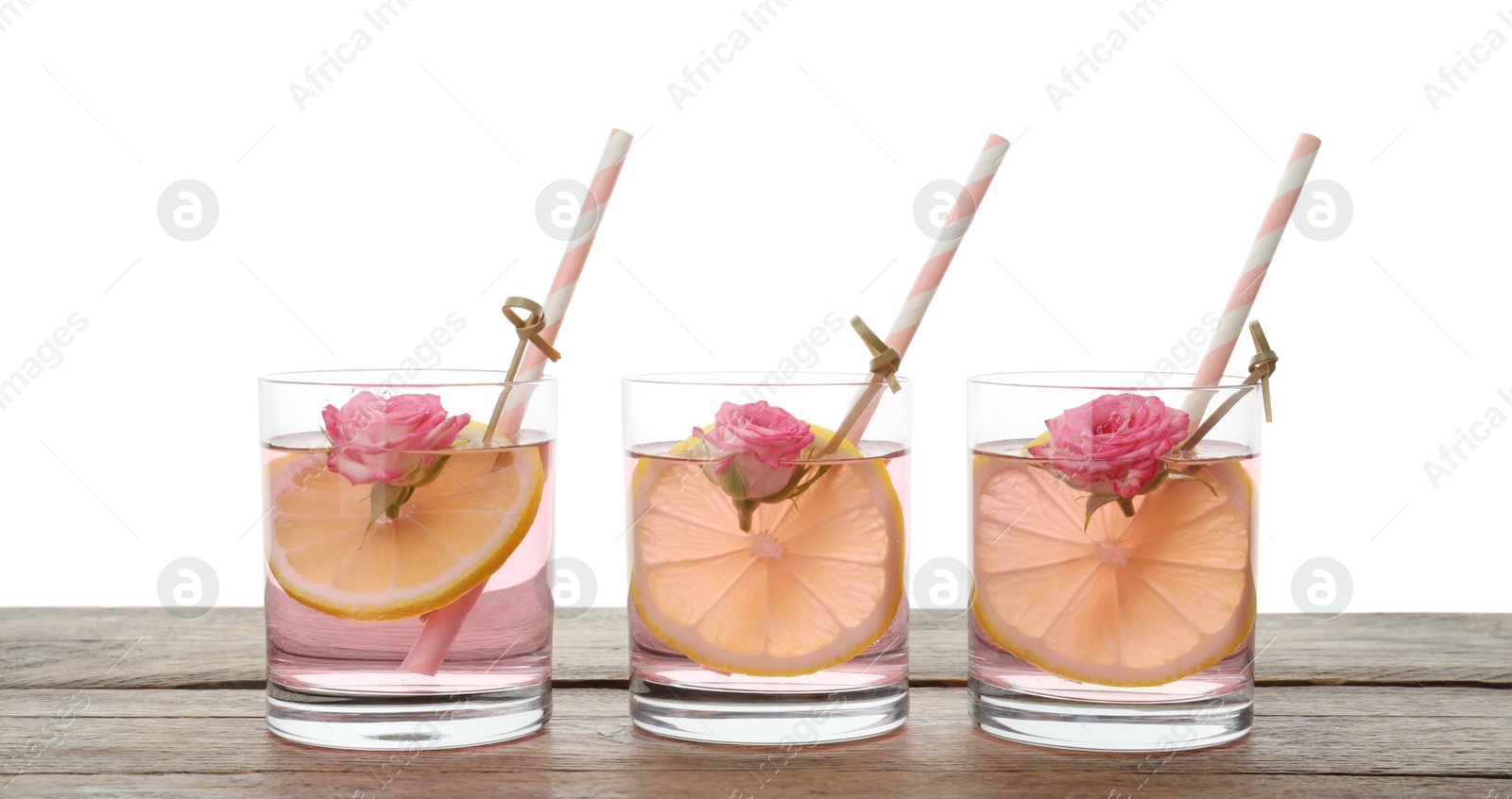 Photo of Refreshing drink with lemon and rose on wooden table