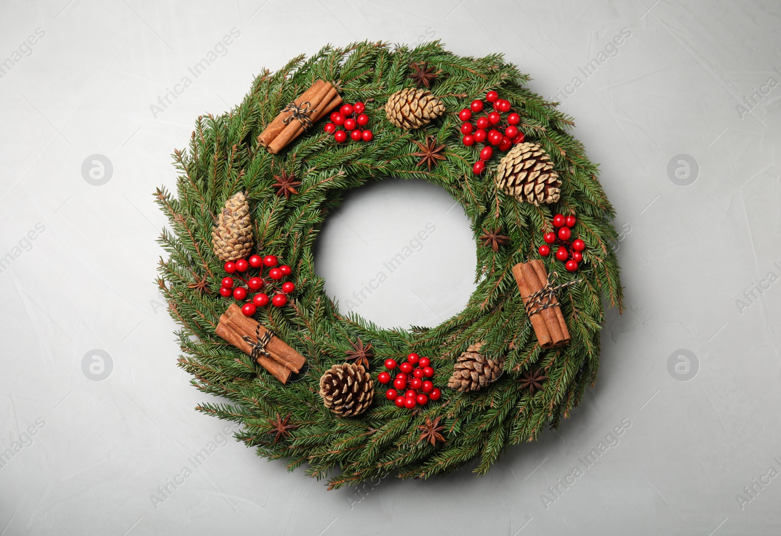 Photo of Beautiful Christmas wreath on light grey background, top view