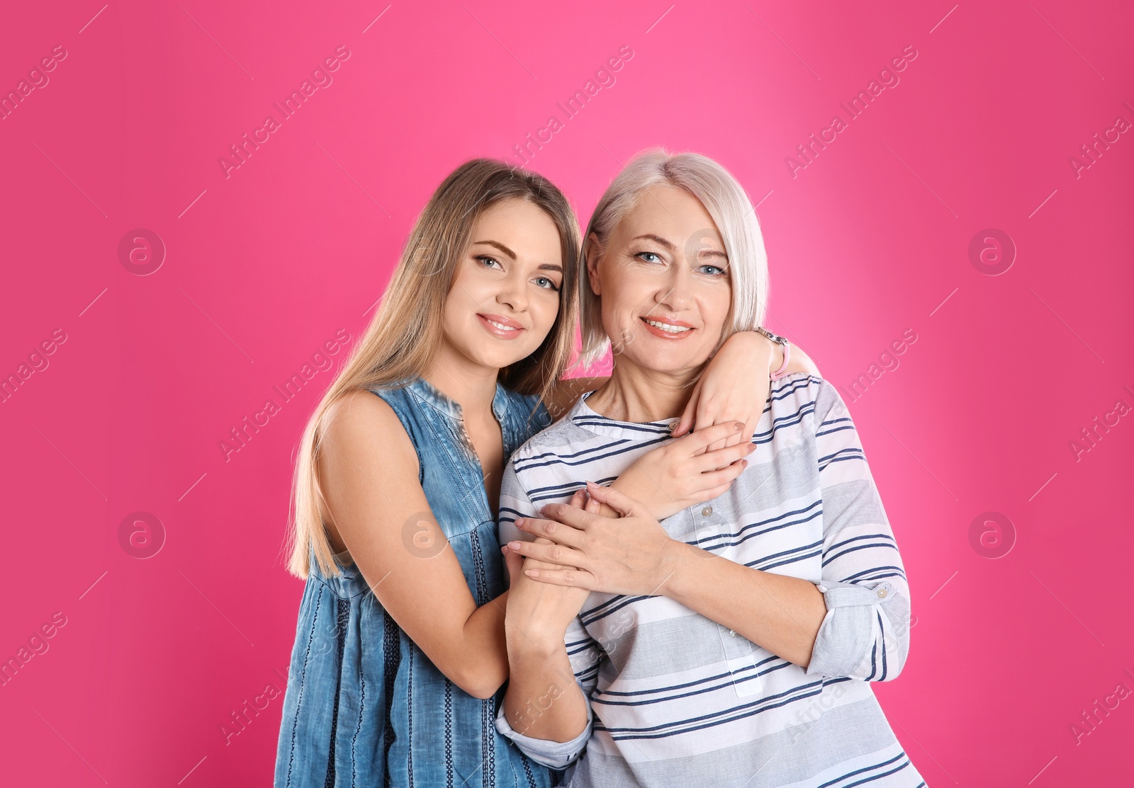 Photo of Portrait of young woman with her mature mother on color background