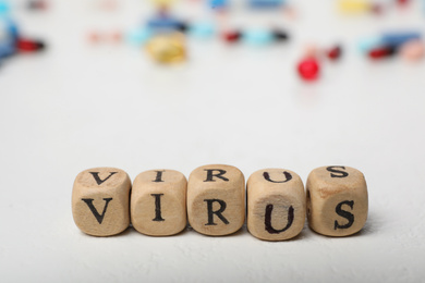 Photo of Word VIRUS made of wooden cubes on white background
