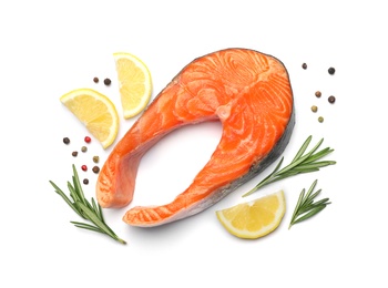 Photo of Fresh raw salmon steak with rosemary and lemon on white background, top view