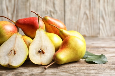 Photo of Ripe pears on wooden table. Healthy snack