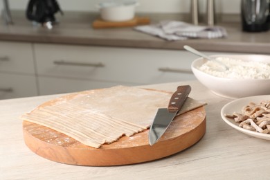 Photo of Making homemade soba (buckwheat noodles) on wooden table in kitchen