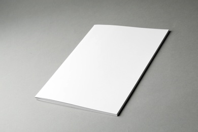 Brochure with blank cover on grey background. Mock up for design