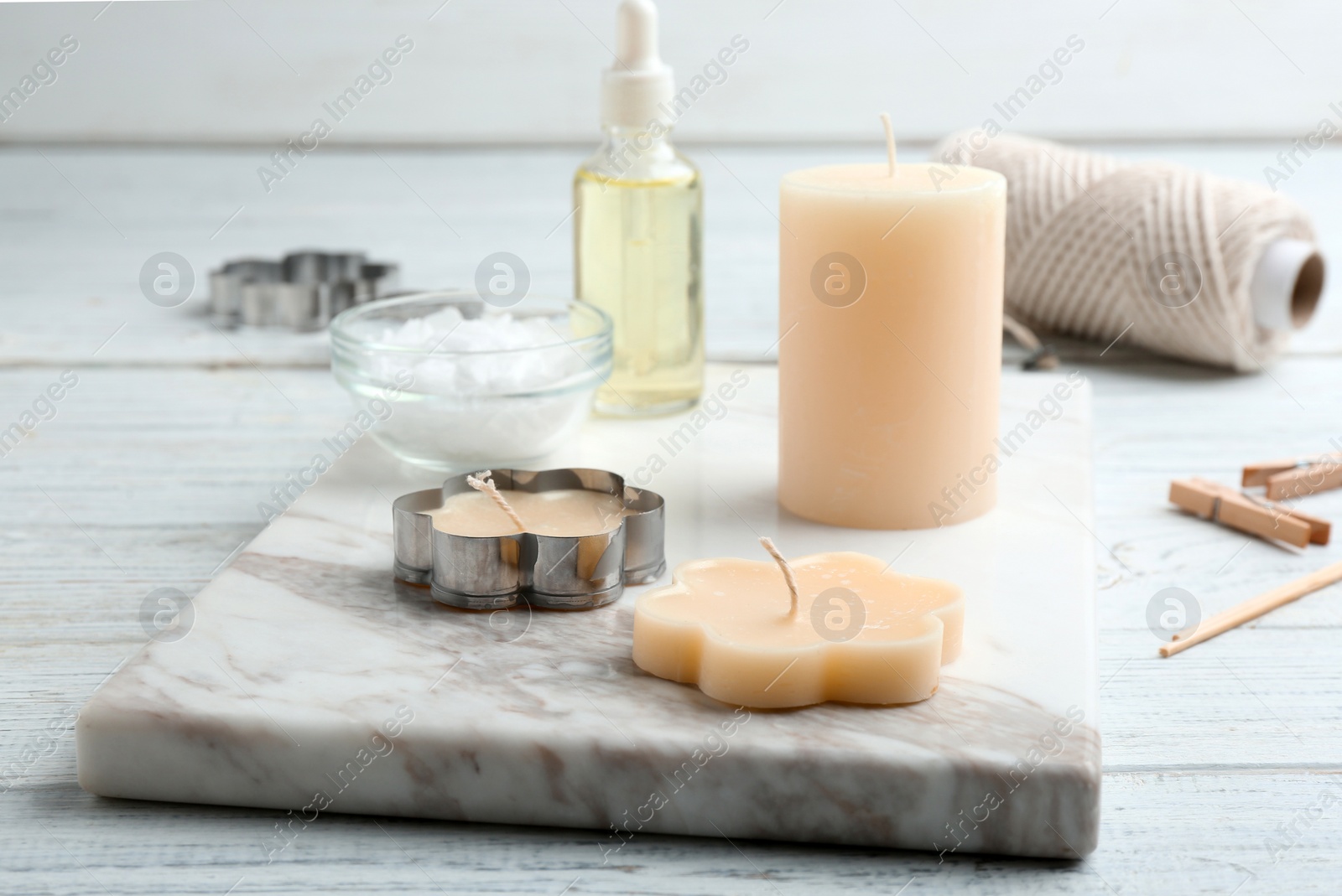 Photo of Handmade candles with cutter on wooden background