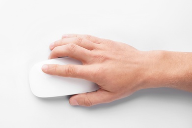 Man using computer mouse on white background, top view