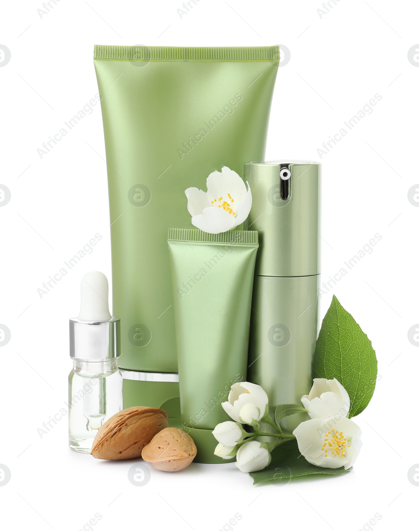 Photo of Set of cosmetic products, almond nuts and flowers isolated on white