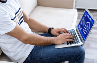 Image of Man using home security app indoors, closeup