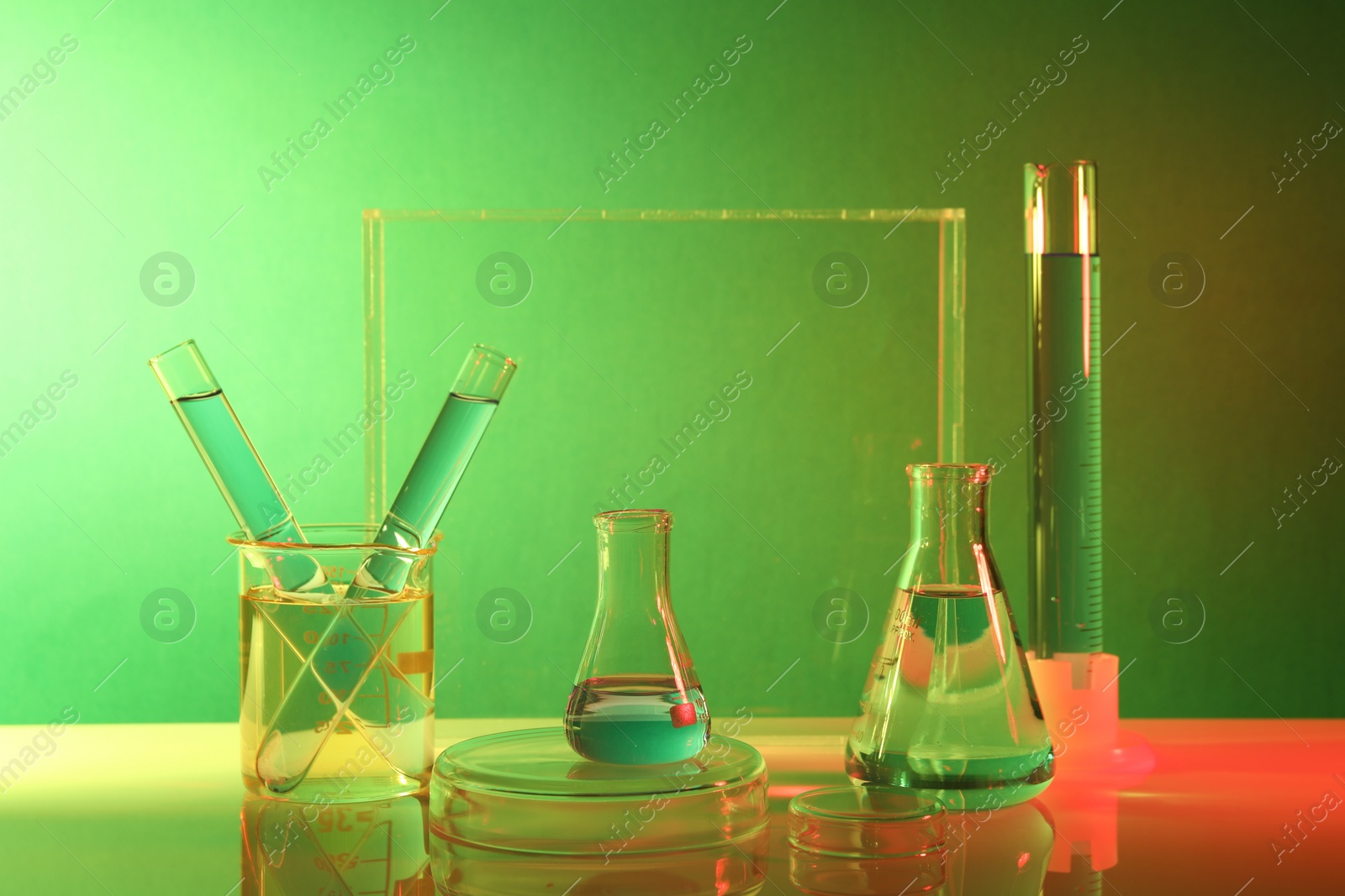 Photo of Laboratory analysis. Different glassware on table against color background