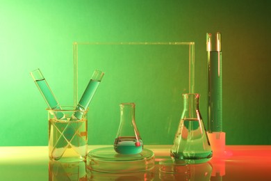 Photo of Laboratory analysis. Different glassware on table against color background