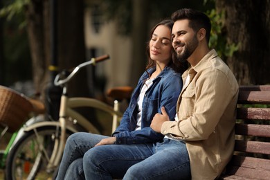 Beautiful couple spending time together in park, space for text