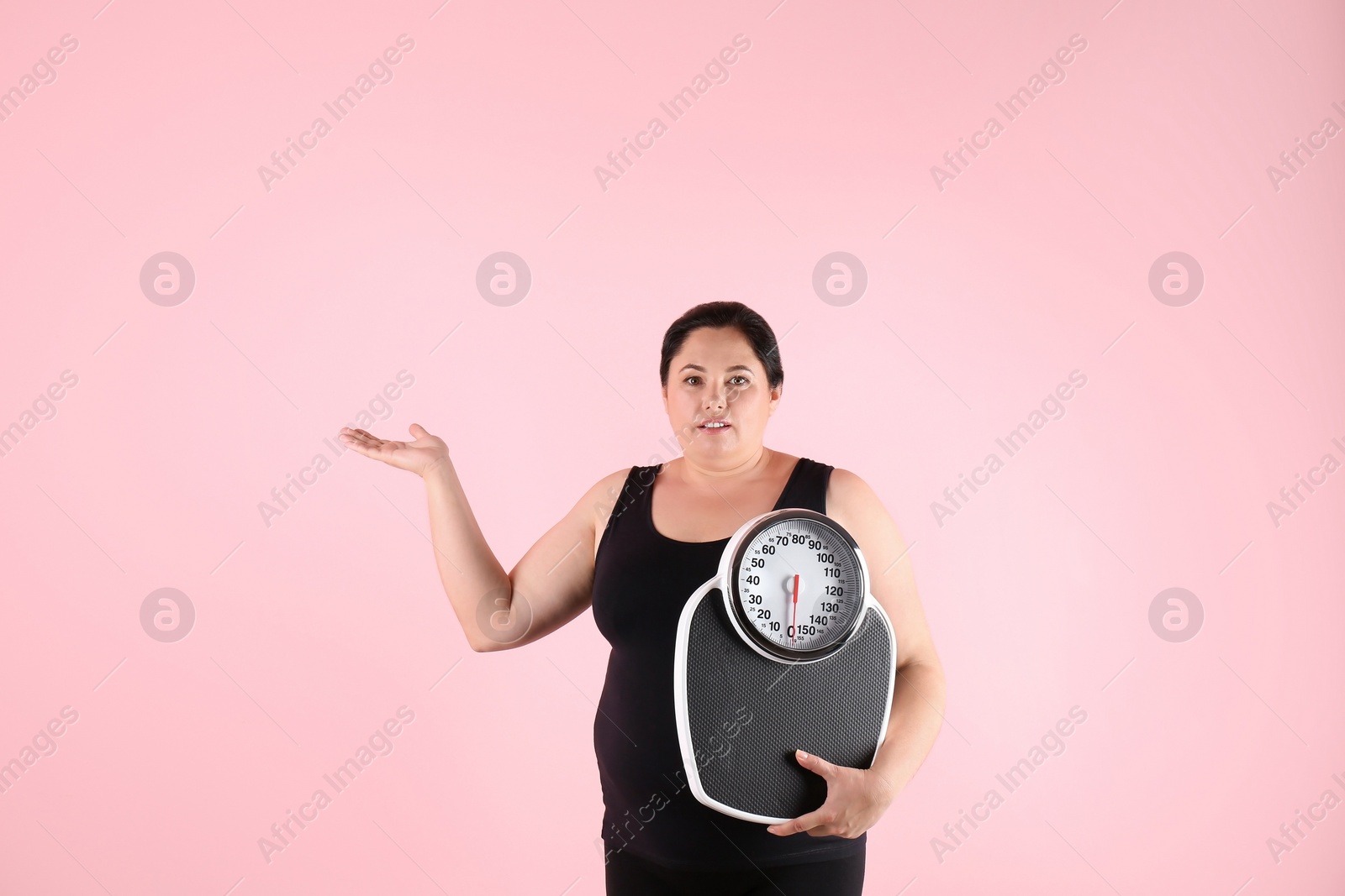 Photo of Overweight woman in sportswear with scales on color background