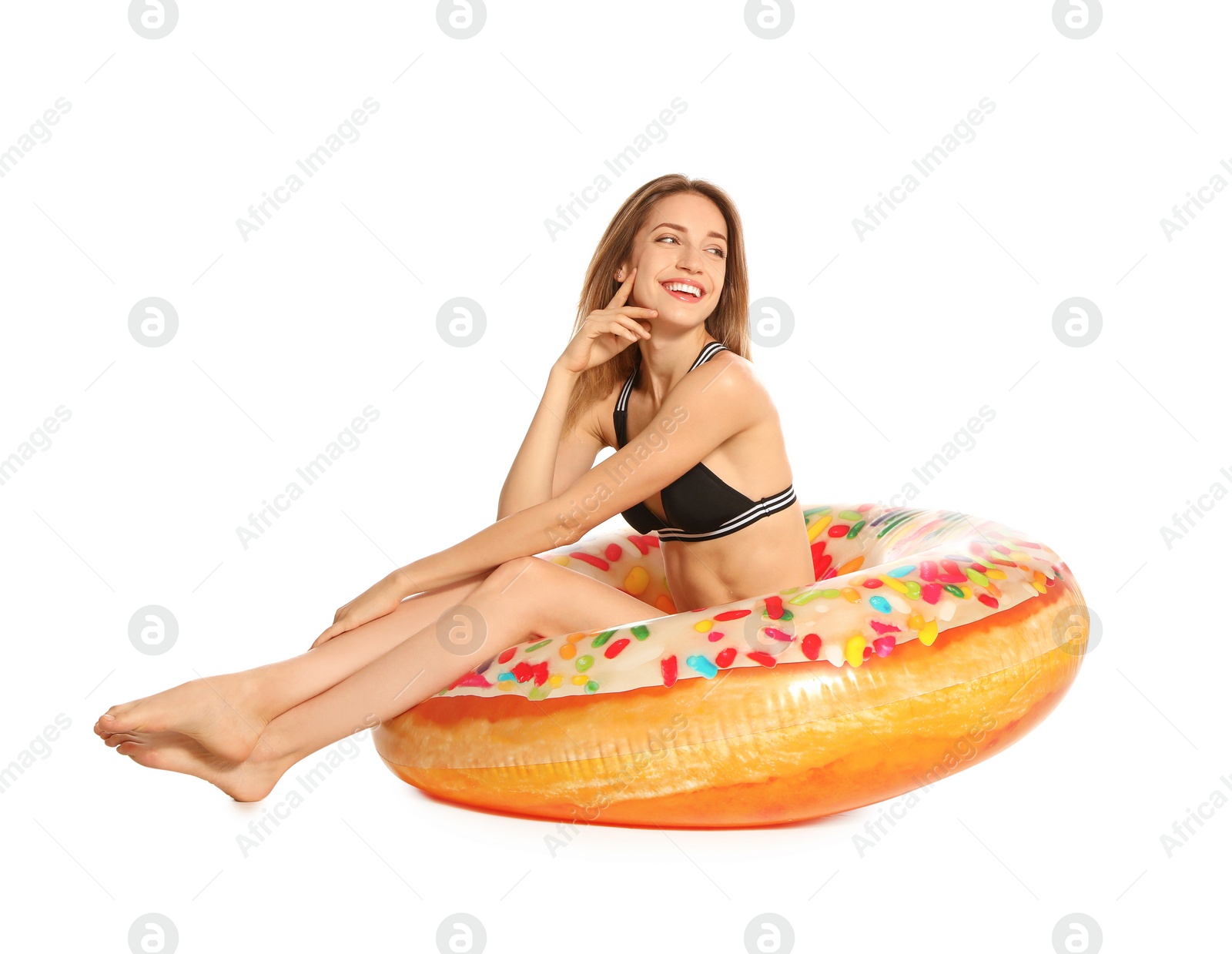 Photo of Beautiful young woman in stylish bikini with doughnut inflatable ring on white background