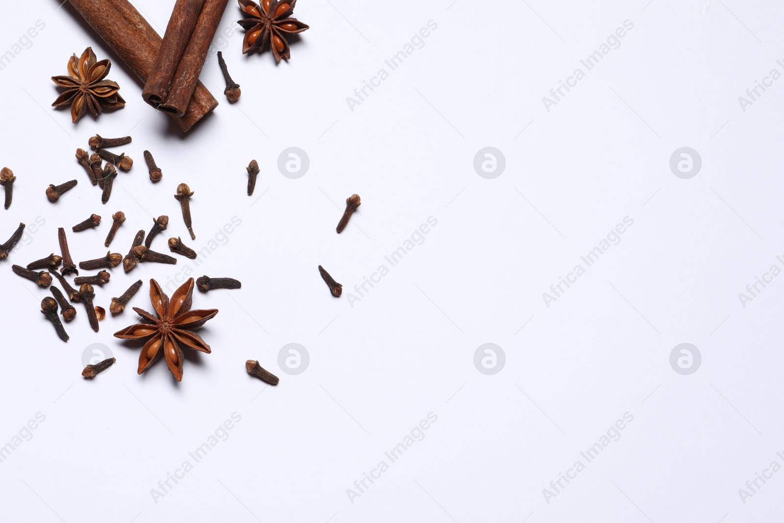 Photo of Different spices on white table, flat lay. Space for text