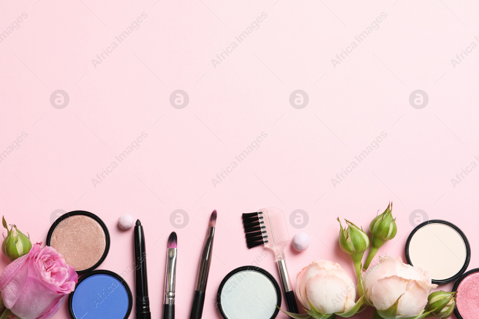 Photo of Flat lay composition with products for decorative makeup on pastel pink background