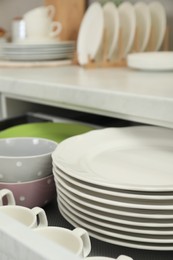 Clean plates, bowls and cups in drawer indoors