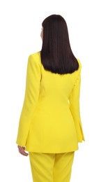 Businesswoman in yellow suit standing on white background