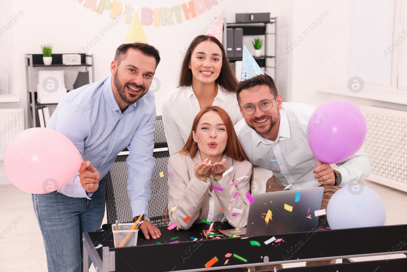 Photo of Coworkers having fun during office party indoors