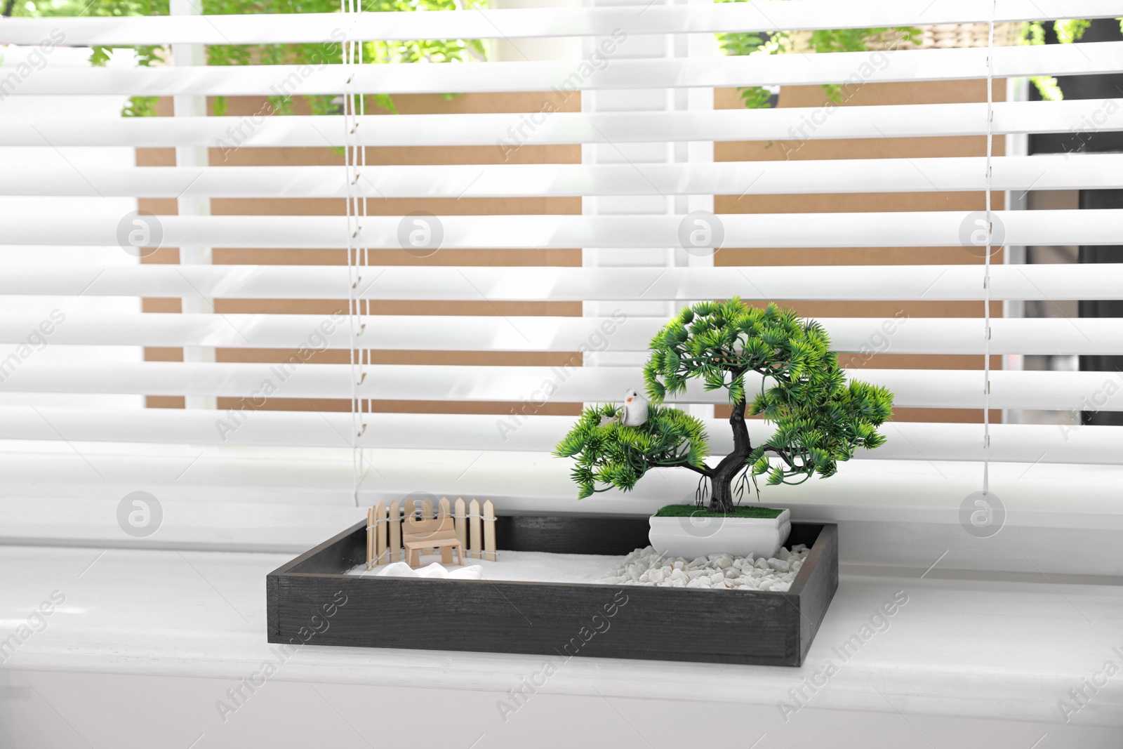 Photo of Beautiful miniature zen garden on window sill