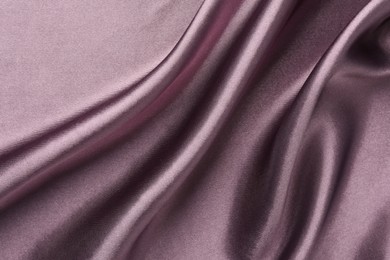 Photo of Crumpled dark purple silk fabric as background, top view