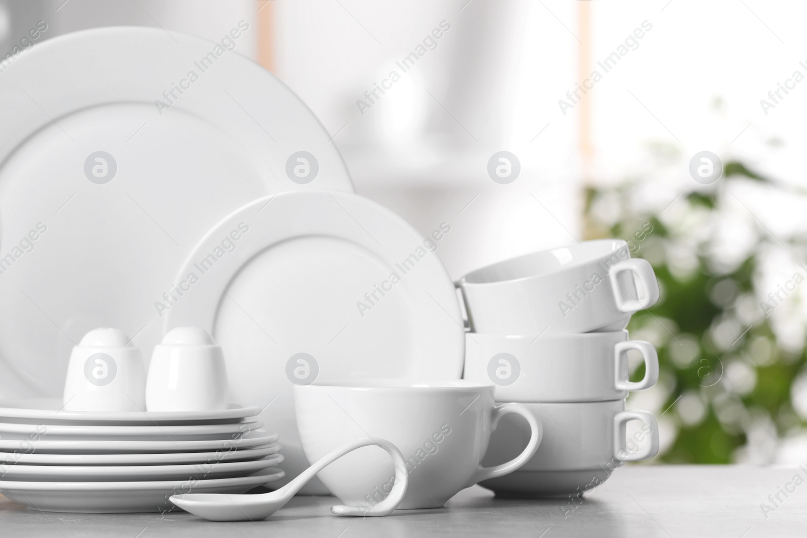 Photo of Set of clean dishware on light table