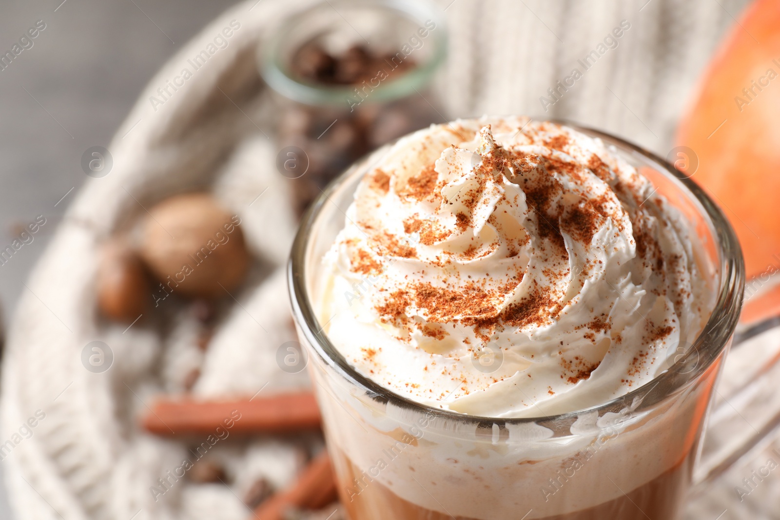 Photo of Glass cup with tasty pumpkin spice latte, closeup