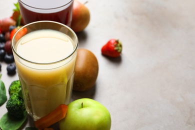 Delicious juice and fresh ingredients on grey table. Space for text